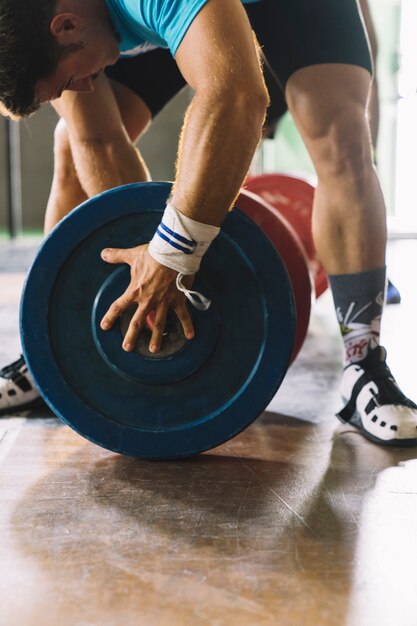 Bodybuilding concept with man and weight plates