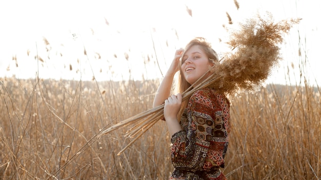 Bohemian woman posing in field