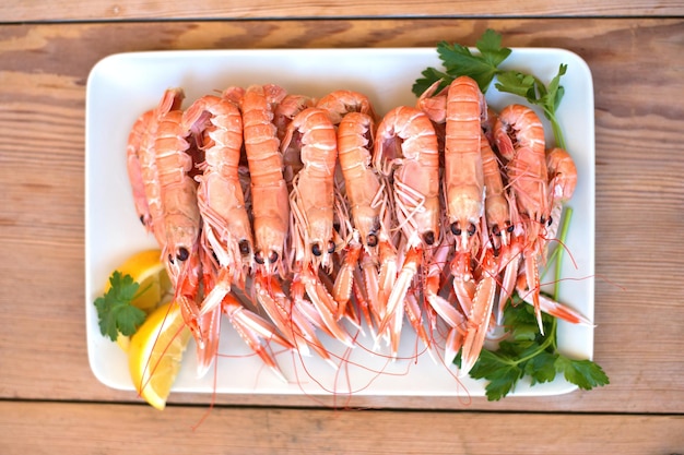 Boiled crayfish, with oil and lemon sauce, on a plate, karavides in Greek