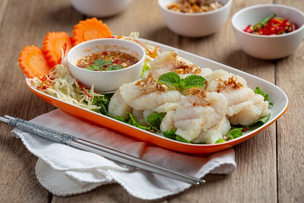 Boiled dolly fish with spicy seafood sauce.