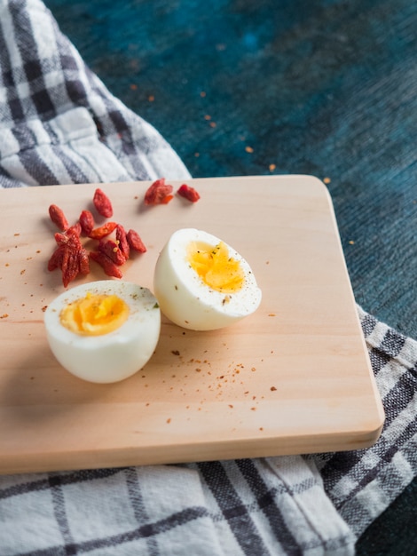 Boiled egg on wooden board