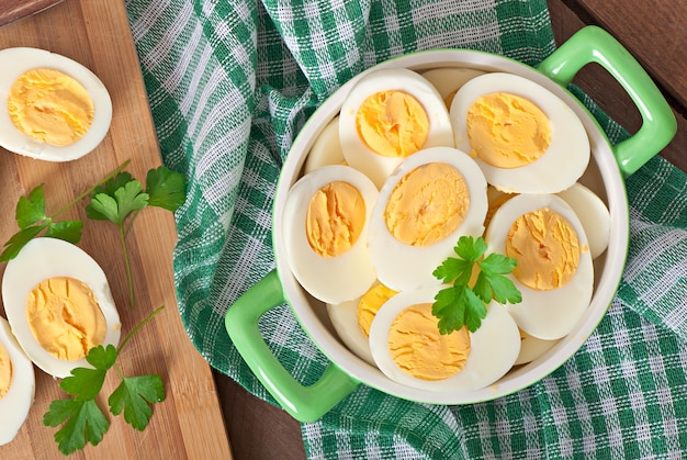 Free photo boiled eggs in a bowl decorated with parsley leaves