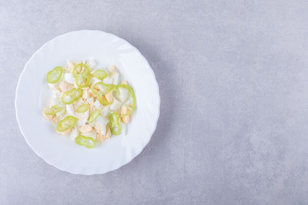 Boiled eggs and pepper slices in white plate. 