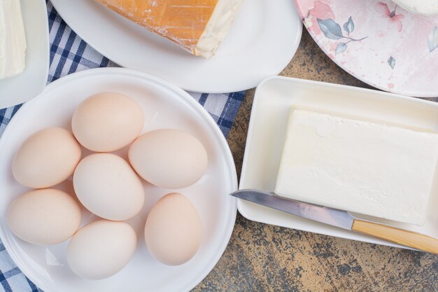 Boiled eggs and various cheese on plates