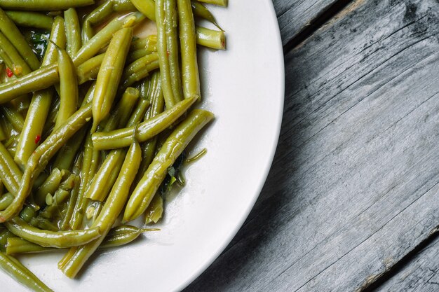 Boiled green beans in a white plate