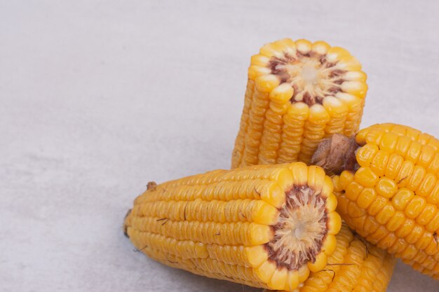 Boiled half cut corns on white surface.