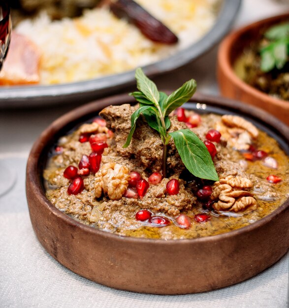 Boiled meat  with pomegranate and walnuts