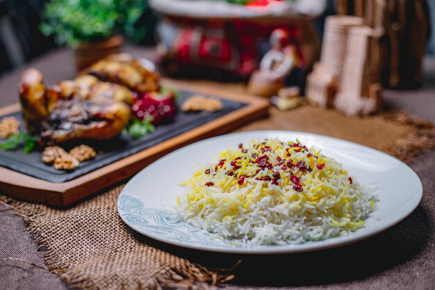 Boiled rice with spice on a white plate on the table