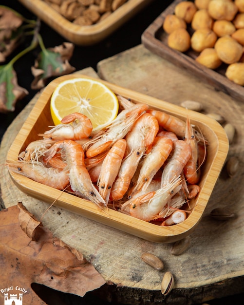 Boiled shrimps in a plate served with lemon