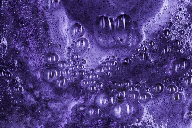 Boiling purple liquid with foam and blobs