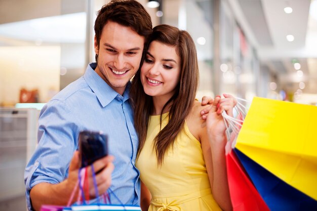 Bonding couple looking at mobile phone