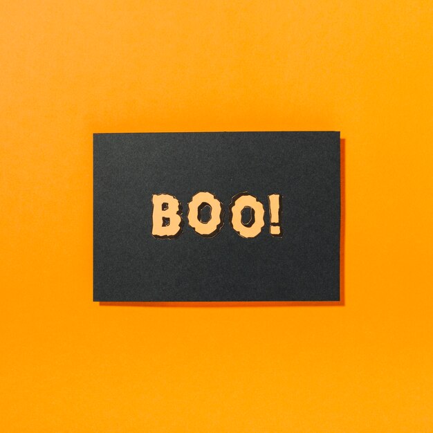 Boo! inscription on piece of black paper