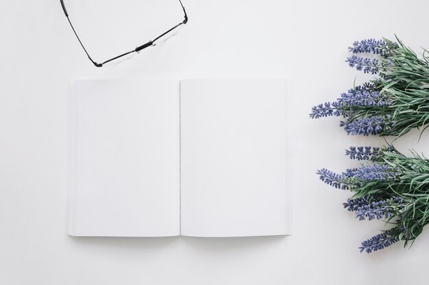 Book cover mockup with flowers and glasses