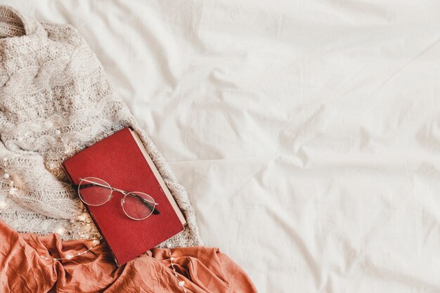 Book and glasses on bed