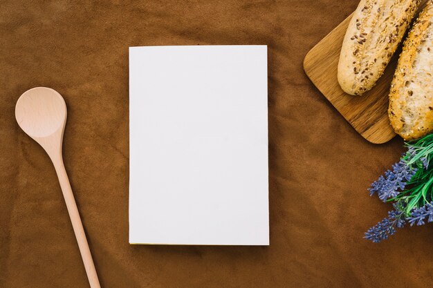 Book mockup with bread, flower and spoon