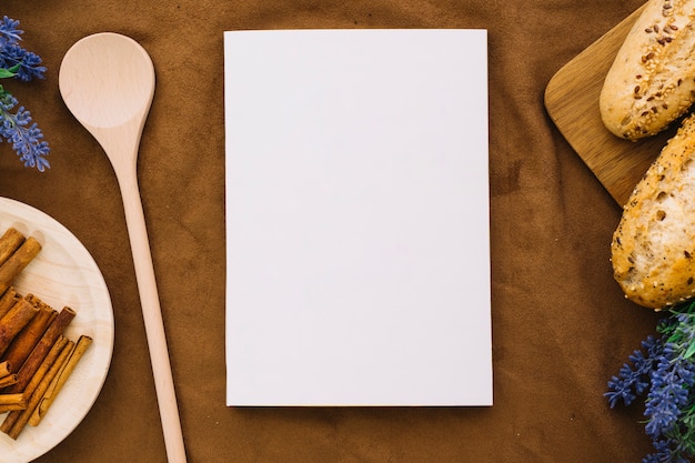 Book mockup with spoon, cinnamon and bread