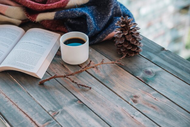 Book near cup on table