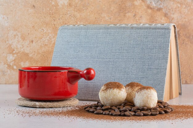 A book with aroma tasty cup of coffee on white background. High quality photo