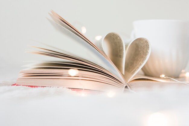 Book with its pages shaping as a heart