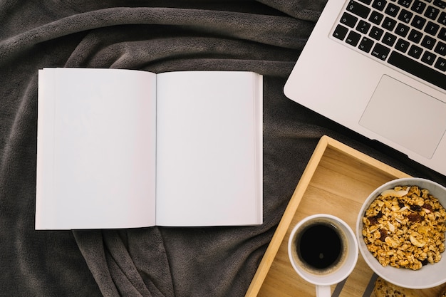 Booklet mockup with coffee, cereals and laptop