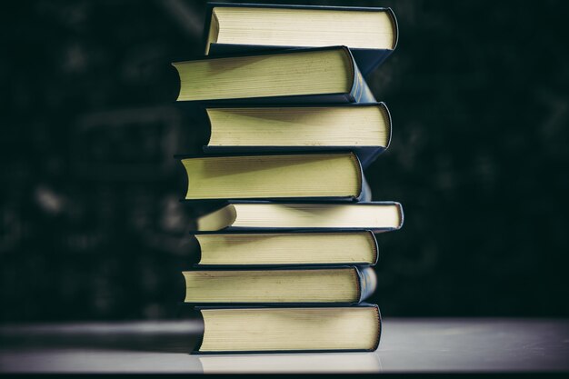 The books are placed in a stack of books on the table