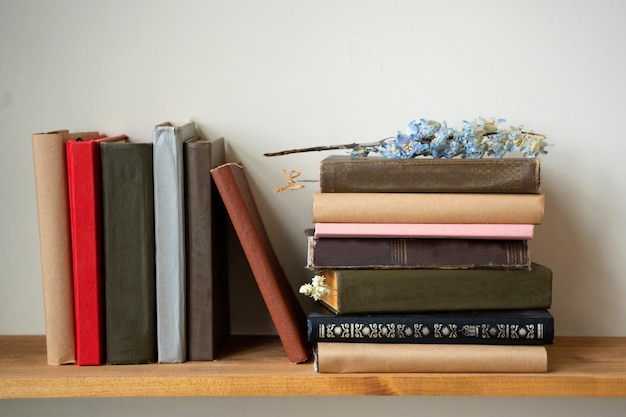 Free photo books arrangement on shelf with flower