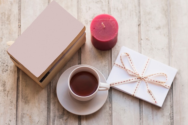 Books, coffee, gift box and red candle