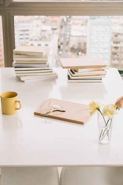 Books and decorations on table near window