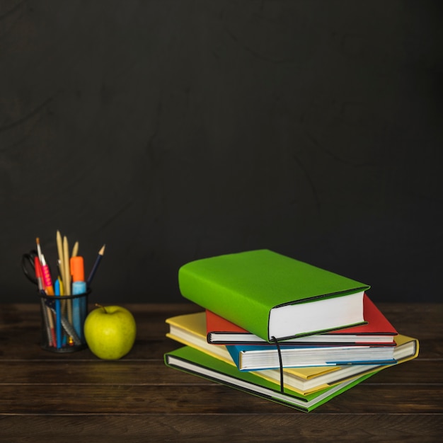 Books on desk with pencil cup