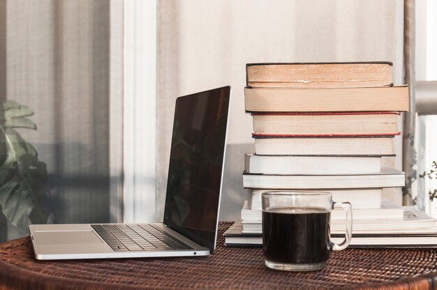 Books near notebook and coffee