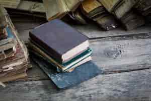 Free photo books piled up on a wooden floor