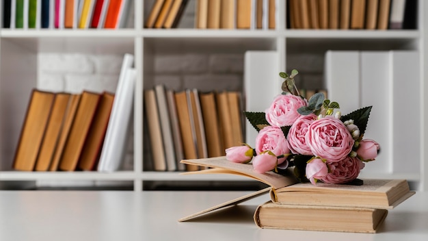 Books on shelf and flowers arrangement