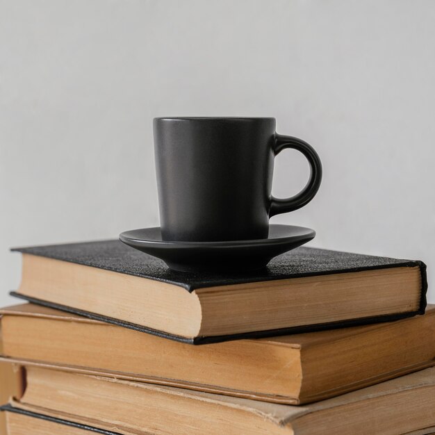 Books stack indoors and coffee cup