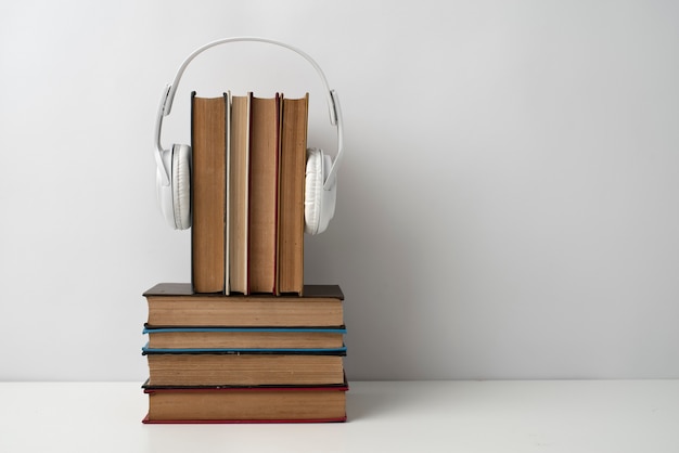 Free photo books stack with headphones