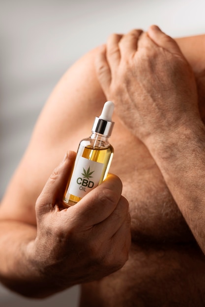 Free photo boomers using cbd oil and cream for treating body pain