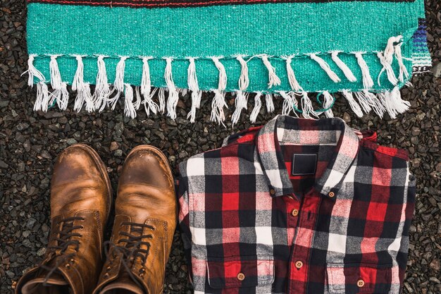 Boots and shirt near blanket