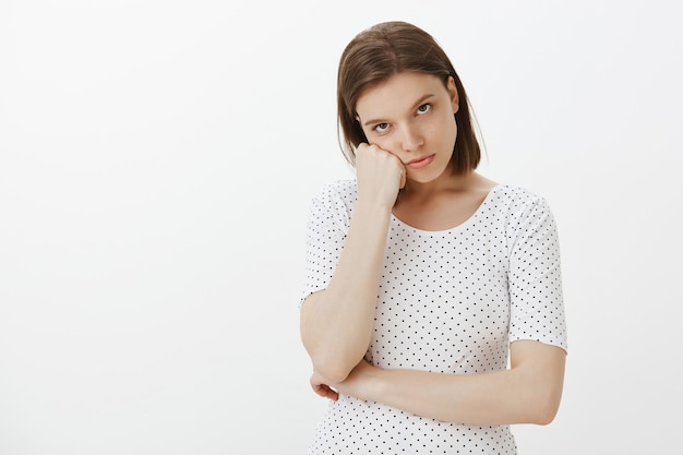 Bored woman looking reluctant, listening to lame story, feeling annoyed