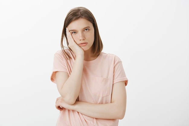 Bored woman student lean on palm and looking indifferent and sleepy