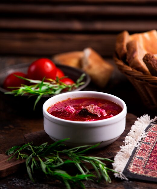 Borsch with meat in a white bowl