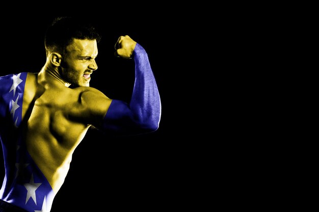 Bosnia and Herzegovina flag on handsome young muscular man black background