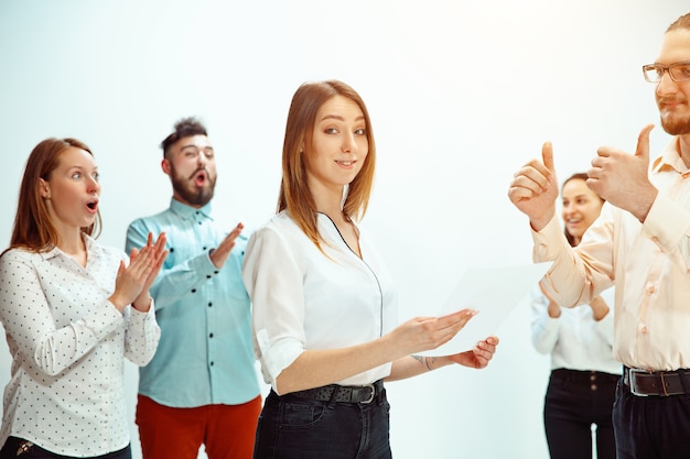 Boss approving and congratulating young successful employee