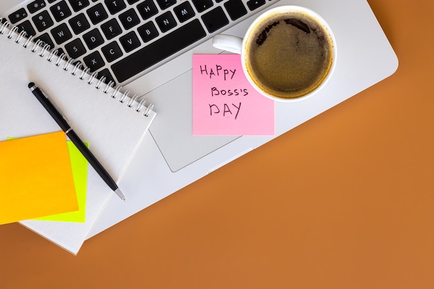 Free photo boss day concept laptop and cup of coffee on table flat lay