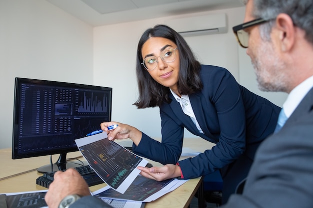 Boss and financial expert discussing trading strategy, studying financial data. Closeup shot. Broker job concept