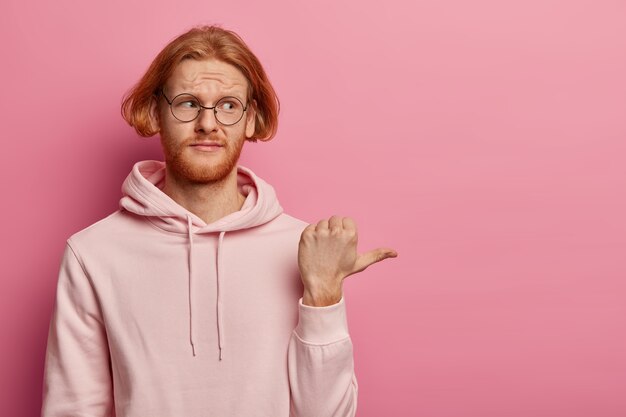 Bothered displeased redhead unshaven guy demonstrates something unpleasant