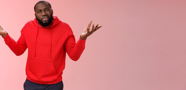 Free photo bothered pissed african american bearded boyfriend in red hoodie arguing standing questioned