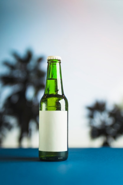 Bottle of beer on blue table