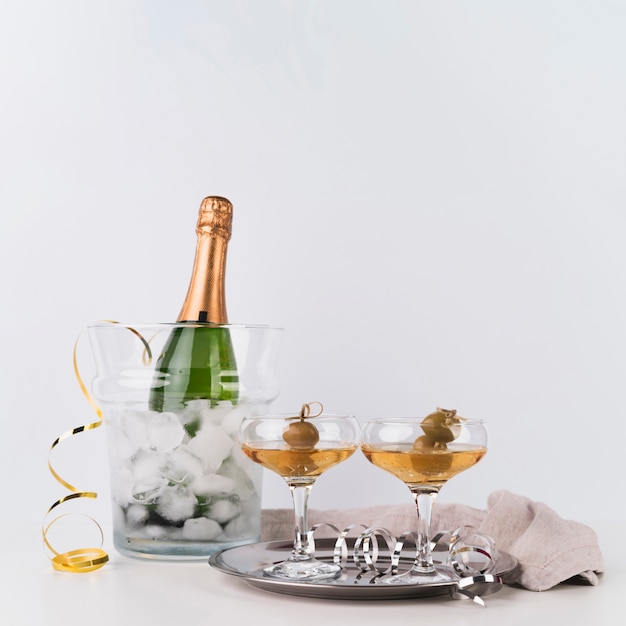 Free photo bottle of champagne with glasses on a tray