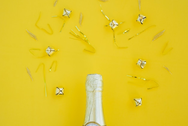 Bottle of drink between silver bells and tinsel 