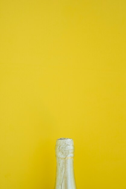 Bottle of drink on yellow background 