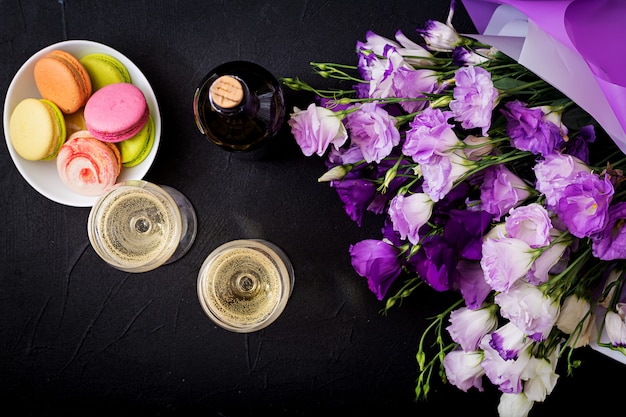 Bottle of dry white wine and a macaroon. Flat lay. Top view.